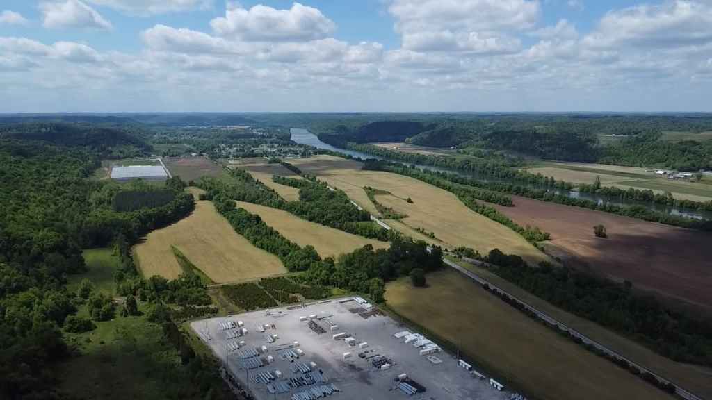 Aerial view of fields, river, and wooded hills in Putnam County